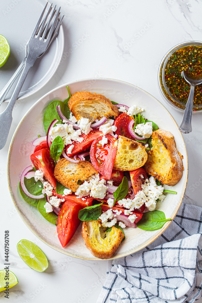 Canvas Prints Italian salad with tomatoes, feta cheese and grilled ciabatta, marble background.