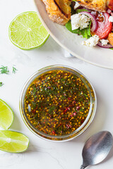 Mustard, olive oil and dill salad dressing in glass jar. Cooking healthy food concept.