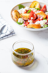 Mustard, olive oil and dill salad dressing in glass jar. Cooking healthy food concept.