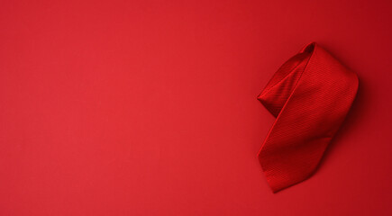 twisted silk red tie on a red background