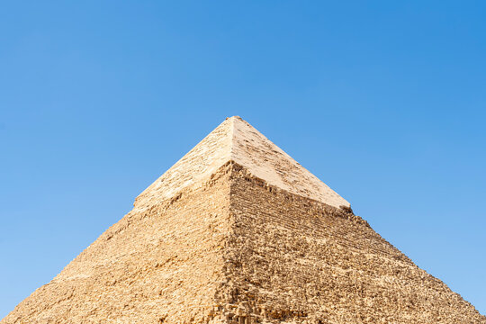 The high pyramid of Chephren on the background of a blue sky with clouds, Giza, Cairo, Egypt. second pyramid. Pyramid of Khafra. The upper part of the second great pyramid. pyramidon.
