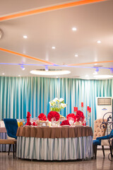 the table in the restaurant is decorated for the event with red napkins