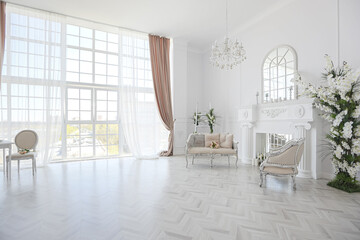 luxurious bright spacious guest room with beautiful chic furniture a huge floor-to-ceiling window...