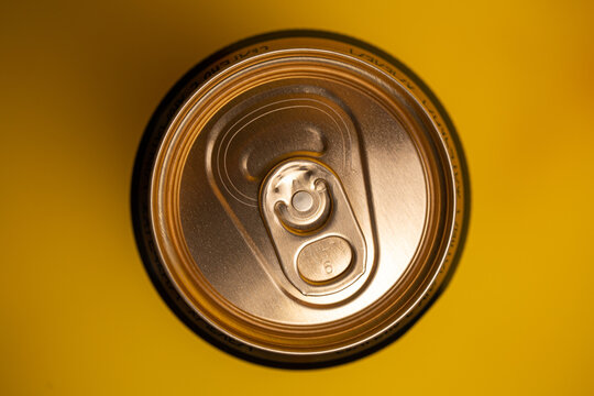 Tin Can Of Beer On A Yellow Background View From Above.