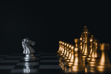 Silver king winner surrounded with silver chess pieces on chess board game competition.concept strategy, leadership and success business.