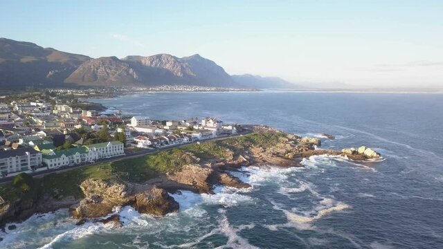Aerial view over pretty seaside town with waves breaking on the coastline