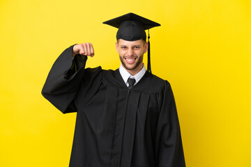 Young university graduate caucasian man isolated on yellow background doing strong gesture