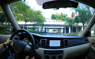 People hands driving car in modern city