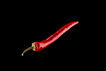 Red hot peppers. Spicy chile cayenne pepper isolated. Red hot chili paprika on black background....