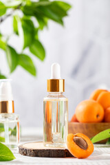 Oil with peach seed extract in a transparent dropper. Natural cosmetics. Copy space.