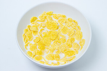Cornflakes with milk on a white background. Healthy and tasty breakfast.