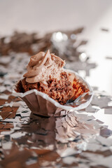 A half-eaten muffin or cupcake after a party. End of the party.