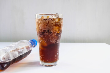 .Glass of soft drinks and black soft drinks on the table