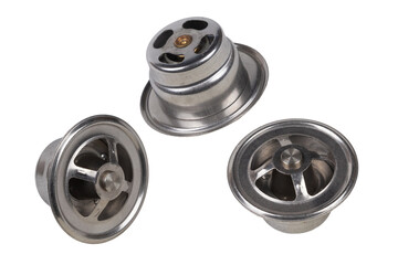 set of three thermostats of the truck engine cooling system. Spare parts on white background