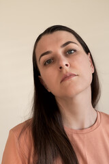 Emotional portrait of young caucasian brunette woman with natural makeup.