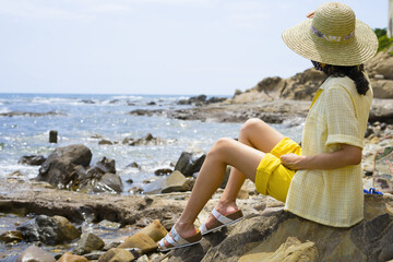 Girl on vacation at the beach with summer outfit