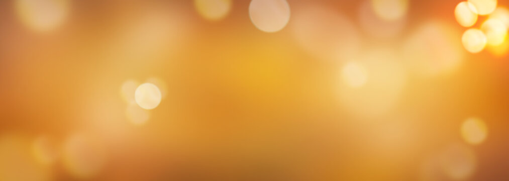 A golden orange and yellow autumn sky background with blurred sun bokeh. Illustration.