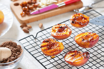 Healthy dessert juicy barbecue peaches with peaches ice cream on the grill