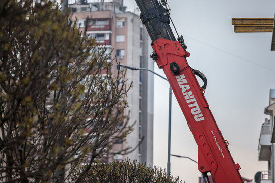 BELGRADE, SERBIA - APRIL 18, 2021: Manitou logo on some crane machinery on a construction site in Belgrade. Groupe Manitou is a French manufacturer of construction industrial equipment.....