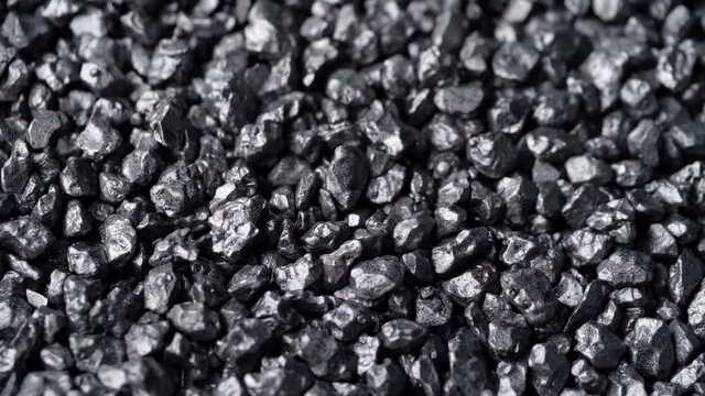 Stone ore close-up. Black stones grunge background.