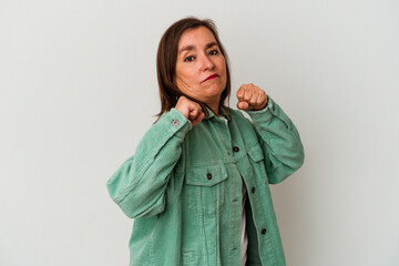 Middle age caucasian woman isolated on white background throwing a punch, anger, fighting due to an argument, boxing.