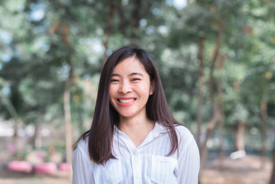 Attractive Adult Business Woman Asian Girl With Happy And Smile Standing On Walk Way Go To Working Between Her Office On Morning Under Green Forest.