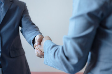 business man and business woman shaking hands for success deal a partnership together. friendship hand shake greeting.