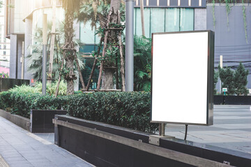big blank billboard white LED screen vertical outstanding in the city side the road traffic for...