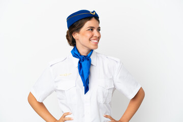 Airplane stewardess caucasian woman isolated on white background posing with arms at hip and smiling