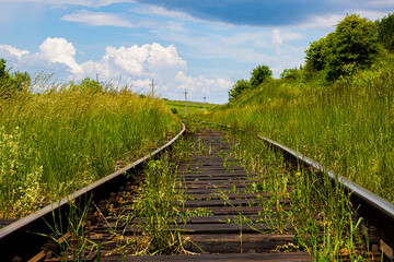 Railway on a background of green grass and sky