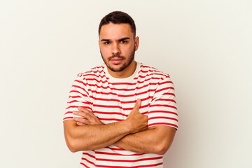 Young caucasian man isolated on white background frowning face in displeasure, keeps arms folded.