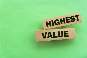 Highest values words on wooden building blocks isolated on green. Social, business and education concept.