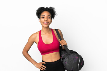 Fototapeta na wymiar Young sport african american woman with sport bag isolated on blue background posing with arms at hip and smiling