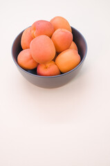 apricots in a dark bowl