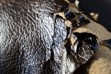 Shabby and worn brown faux leather texture background with cracks and damages, repairman...