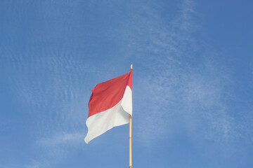 Indonesian national flag with blue sky background