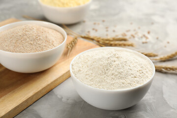 Bowls with different flours on light grey table