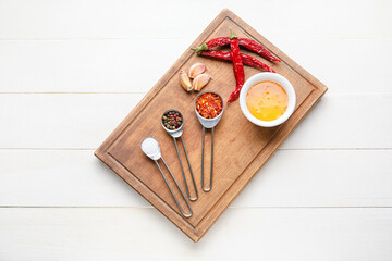 Fototapeta na wymiar Board with honey and spices on light wooden background
