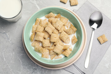 Bowl with tasty corn pads and milk on light grey marble table, flat lay