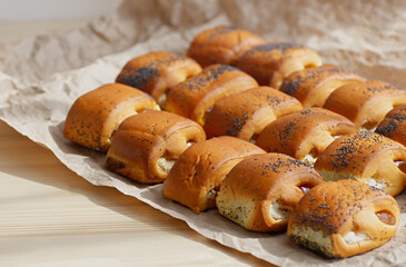 Homemade buns with fruit jam on a background of crumpled pastry paper. Selective focus. Close-up.