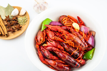 Spicy crayfish in a pot on white background