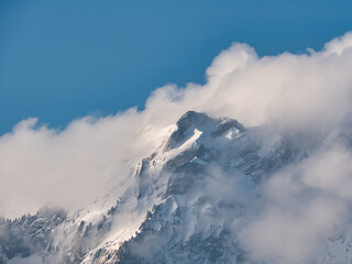 Fototapeta na wymiar Rock formation at Mount Pilatus in winter with snow and clouds