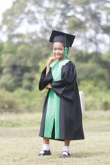 A portrait of an Asian female student graduating from kindergarten.