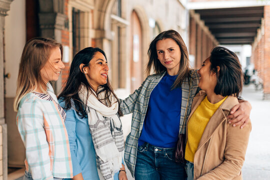 Self Confident Attractive Young Woman Looking To The Camera Surrounded By Girls Friends