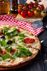 Brazilian-style pizza with mozzarella, sun-dried tomatoes and arugula.