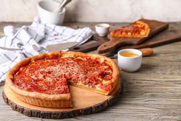 Tasty Chicago-style pizza on wooden table