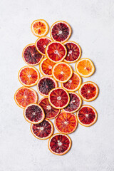 Fresh ripe sliced blood oranges on white background. Top view, flat lay. Colorful blood orange...
