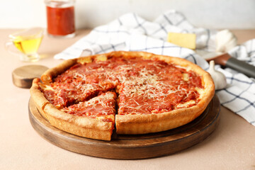 Board with tasty Chicago-style pizza on table