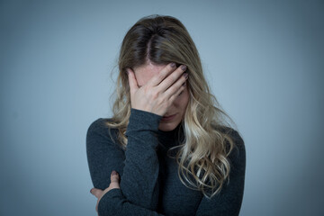Portrait of young attractive caucasian woman suffering from depression, stress and anxiety. Sad and lonely woman crying, feeling depressed, distressed, worried and overwhelmed. Mental Health care.