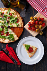 Brazilian-style pizza with mozzarella, sun-dried tomatoes and arugula. Top view.